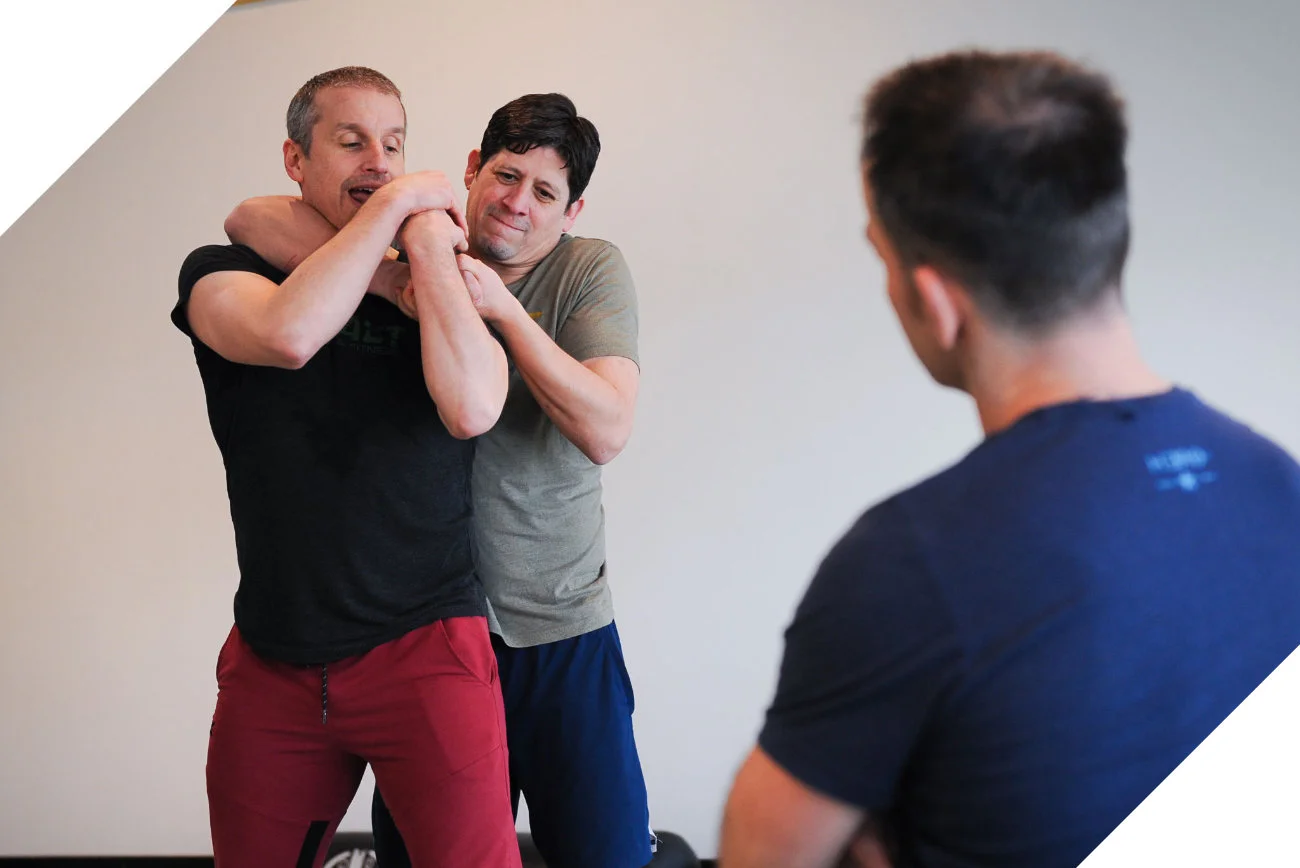 Demonstration using Krav Maga to defend against a choke from behind